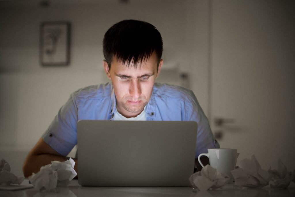 Your Laptop is Dying Faster? Here’s the Shocking Reason & How to Fix It ? 1 portrait man with laptop late night screen light 1